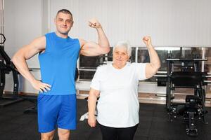 An elderly pensioner plays sports in the gym photo