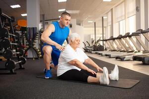 An elderly pensioner plays sports in the gym photo