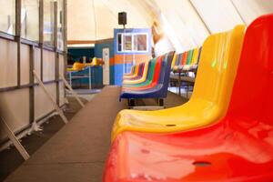 Multi-colored seats. ice rink. Sports stadium, stands for fans. photo