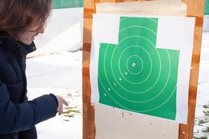 consiguiendo dentro el parte superior diez golpear el objetivo. neumático, papel objetivo, pistola tiros foto