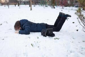 A man falls in the snow. The man slipped and was injured. Falling on ice. Winter. Fracture, bruise, dislocation. photo