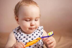 dental hygiene. happy little girl brushing her teeth photo