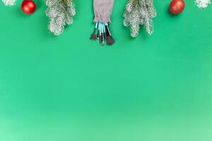 Christmas, New Year's background for make-up artist. brushes, Christmas decorations, spruce. Empty space for text. photo