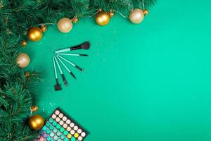 Christmas, New Year's background for make-up artist. brushes, Christmas decorations, spruce. Empty space for text. photo