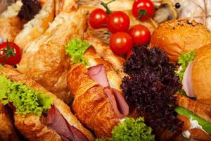 Delivery of food in a box, delicious and fresh food. Convenient boxing for eating at home, at work, in nature. Croissants with ham, burgers, pastries, buns photo