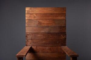 A wooden throne chair on a gray background in a photo studio