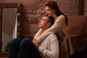 Young people in love in a photo studio. Teenagers, love. Brown interior, posing for models