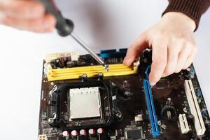 Technological background with closeup on tester checking motherboard. photo