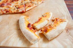 Pizza on a wooden tray. Dry crusts of the edge of the pizza photo