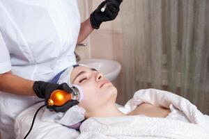 The beautician performs the procedure of electroporation photo