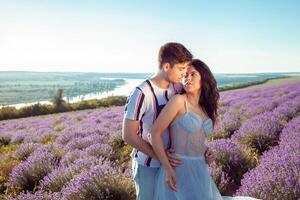 Loved people in a lavender field, a man and a woman love each other photo