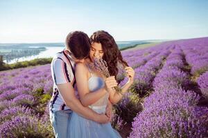 Loved people in a lavender field, a man and a woman love each other photo