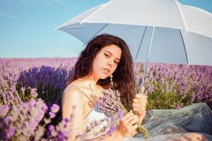 Young beautiful model girl with a white umbrella photo