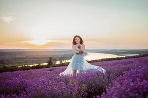 A beautiful young girl against the sunset and a beautiful sky photo