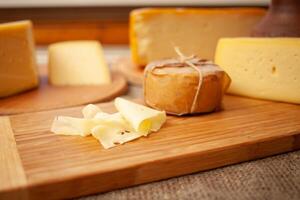 Beautiful background, cheese on wooden board, food. Home natural eco-friendly production, business. product set photo