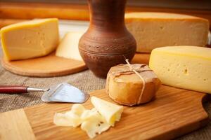 Beautiful background, cheese on wooden board, food. Home natural eco-friendly production, business. photo