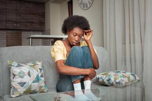 Portrait of African American Black Woman. Depression, headache, loneliness after a breakup, mental illness, stress at work, longing, sadness. Unhappy photo