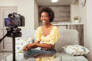 African American black woman blogger records video on channel, online broadcast. Courses, business. Smiling, happy. looks into camera photo