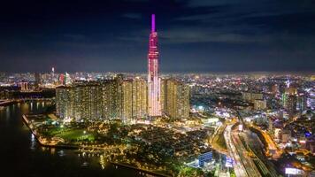 Aerial sunset view at Landmark 81 - it is a super tall skyscraper and Saigon bridge with development buildings along Saigon river, cityscape in the night photo