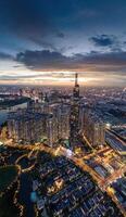 Aerial sunset view at Landmark 81 - it is a super tall skyscraper and Saigon bridge with development buildings along Saigon river, cityscape in the night photo