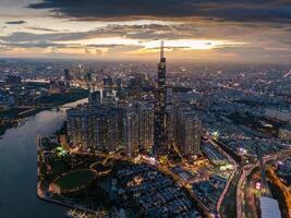 Aerial sunset view at Landmark 81 - it is a super tall skyscraper and Saigon bridge with development buildings along Saigon river, cityscape in the night photo