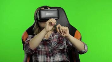 Girl using VR app helmet to play simulation dance game. Woman watching virtual reality 3d video