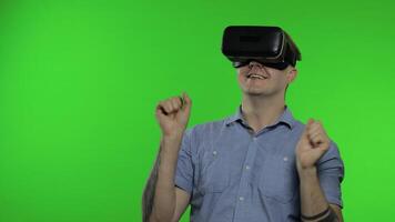 Man using VR app helmet to play simulation game, drawing. Guy watching virtual reality 3d video