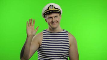 Young sailor man waving hands. Seaman guy in sailor's vest. Chroma key video