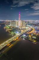 Aerial sunset view at Landmark 81 - it is a super tall skyscraper and Saigon bridge with development buildings along Saigon river, cityscape in the night photo