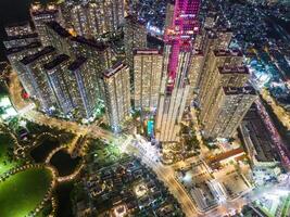 Aerial sunset view at Landmark 81 - it is a super tall skyscraper and Saigon bridge with development buildings along Saigon river, cityscape in the night photo