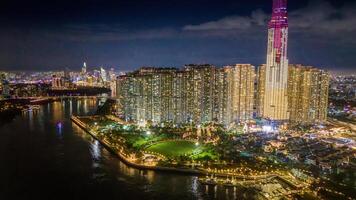 Aerial sunset view at Landmark 81 - it is a super tall skyscraper and Saigon bridge with development buildings along Saigon river, cityscape in the night photo