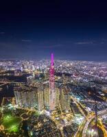 Aerial sunset view at Landmark 81 - it is a super tall skyscraper and Saigon bridge with development buildings along Saigon river, cityscape in the night photo