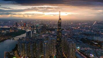 Aerial sunset view at Landmark 81 - it is a super tall skyscraper and Saigon bridge with development buildings along Saigon river, cityscape in the night photo