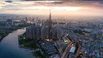 Aerial sunset view at Landmark 81 - it is a super tall skyscraper and Saigon bridge with development buildings along Saigon river, cityscape in the night photo