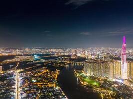 Aerial sunset view at Landmark 81 - it is a super tall skyscraper and Saigon bridge with development buildings along Saigon river, cityscape in the night photo