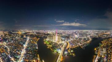 Aerial sunset view at Landmark 81 - it is a super tall skyscraper and Saigon bridge with development buildings along Saigon river, cityscape in the night photo