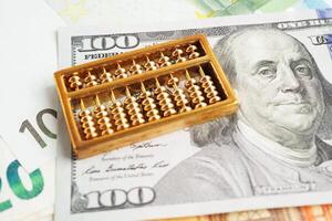 Gold abacus on banknote money, finance trading investment business currency concept. photo