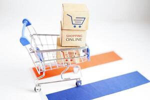 Online shopping, Shopping cart box on Netherlands flag, import export, finance commerce. photo