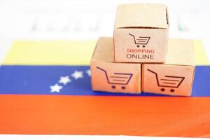 Online shopping, Shopping cart box on Venezuela flag, import export, finance commerce. photo