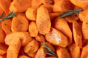 AI generated Carrots cut into pieces, seasoned with spices and olive oil, lie on baking tray. photo