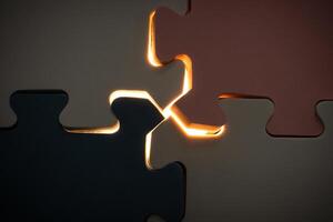 Concept for teamwork and problem solving. Under exposure view of jigsaw puzzle with a glowing light. After some edits. photo