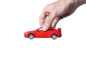 Hand holding a toy car isolated on white background. After some edits. photo