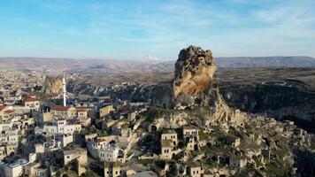 Aerial drone view of the Ortahisar Castle in Cappadocia, Turkey with the snow capped Mount Erciyes in the background. video