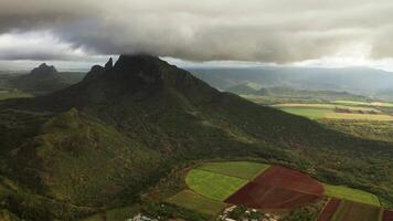 shooting from top to bottom the peaks of mountains and jungles of Mauritius, the sky in clouds video