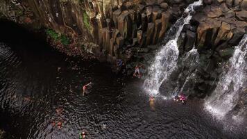 un familia en el antecedentes de el Rochester cascada en el isla de Mauricio en el selva video