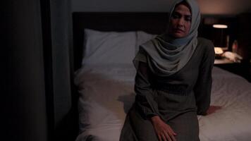 Woman wearing a hijab is thinking and feeling bad. She is depressed and not feeling well video