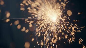 Welding sparks, slow motion. A worker uses a welding machine. Metal welder working with arc welding machine to weld steel at factory while wearing safety equipment. video