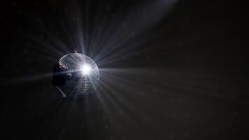 Disco Ball with Reflected Moving Rays Rotating. Mirror disco ball in white light. Isolated disco ball on black background. Close-up. Mirror ball spinning indoors. Performance. The reflection of lights video