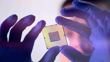 CPU in hands of a technician. The processor is being examined for apparent defects. In Modern Electronic Manufacturing Factory Design Engineer Holds Microchip. Close-up a New Generation Microchip. video