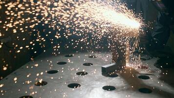 Welding sparks, slow motion. A worker uses a welding machine. Metal welder working with arc welding machine to weld steel at factory while wearing safety equipment. video